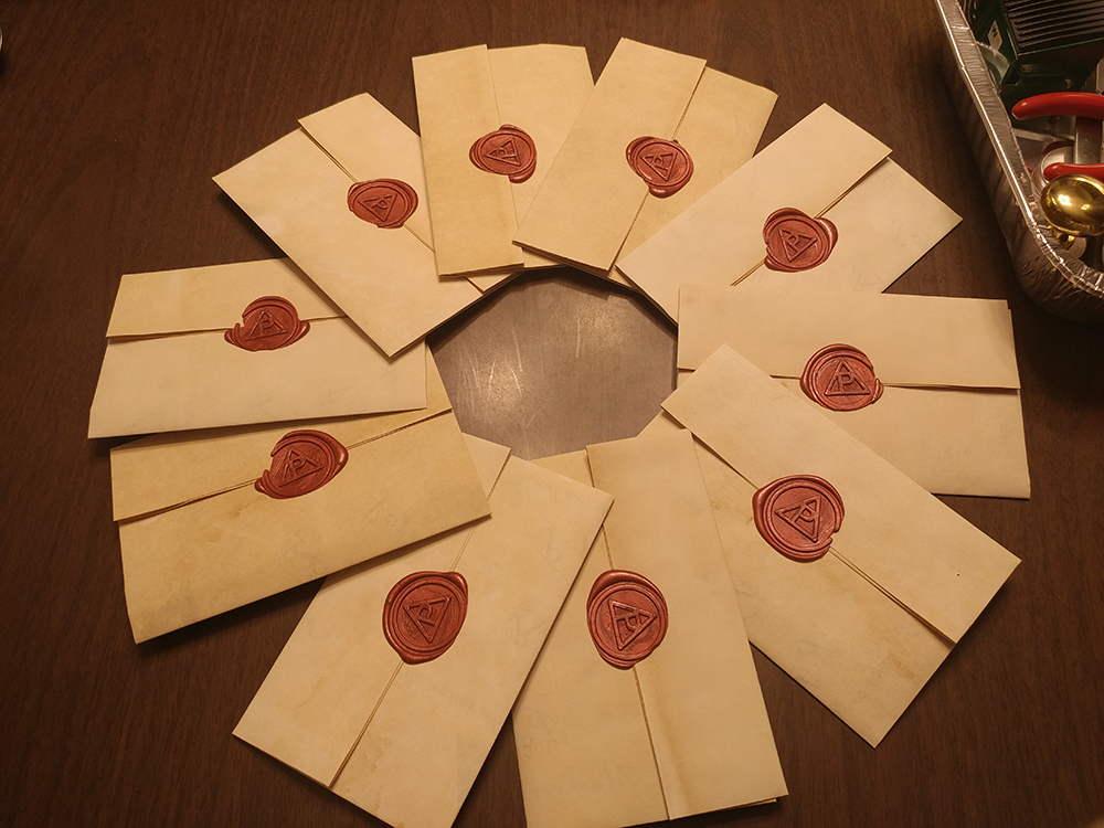 Old looking ball invites with custom wax seals made by Ion Roux